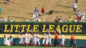 Aug 25, 2013; Williamsport, PA, USA; Japan players celebrate after defeating California (West) 6-4 in the Little League World Series championship game at Lamade Stadium. Mandatory Credit: Matthew O