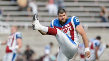 MONTREAL, QC - AUGUST 29: Ryan Bomben #64 of the Montreal Alouettes stretches prior to the CFL game against the Ottawa Redblacks at Percival Molson Stadium on August 29, 2014 in Montreal, Quebec, Canada. The Alouettes defeated the Redblacks 20-10. (Photo by Minas Panagiotakis/Getty Images)