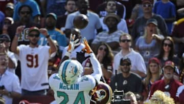 Sep 13, 2015; Landover, MD, USA; Miami Dolphins defensive back Brice McCain (24) intercepts a pass over Washington Redskins wide receiver Pierre Garcon (88) during the second half at FedEx Field. Mandatory Credit: Brad Mills-USA TODAY Sports