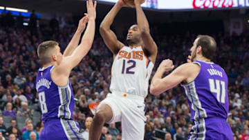 The Phoenix Suns' TJ Warren (12) drives to the basket against the Sacramento Kings' Bogdan Bogdanovic (8) on Friday, Dec. 29, 2017, at the Golden 1 Center in Sacramento, Calif. (Hector Amezcua/Sacramento Bee/TNS via Getty Images)