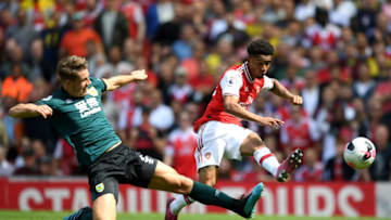 LONDON, ENGLAND - AUGUST 17: Reiss Nelson of Arsenal shoots under pressure from James Tarkowski of Burnley during the Premier League match between Arsenal FC and Burnley FC at Emirates Stadium on August 17, 2019 in London, United Kingdom. (Photo by Michael Regan/Getty Images)