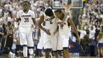 Nov 14, 2014; Storrs, CT, USA; Connecticut Huskies guard/forward Daniel Hamilton (5) reacts with Connecticut Huskies guard Ryan Boatright (11) after a play against the Bryant University Bulldogs during the second half at Harry A. Gampel Pavilion. Uconn defeated Bryant 66-53. Mandatory Credit: David Butler II-USA TODAY Sports