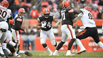 CLEVELAND, OHIO - JANUARY 09: Running back Nick Chubb #24 runs for a gain as offensive tackle Jedrick Wills #71 of the Cleveland Browns blocks defensive tackle Renell Wren #95 of the Cincinnati Bengals during the second half at FirstEnergy Stadium on January 09, 2022 in Cleveland, Ohio. The Browns defeated the Bengals 21-16. (Photo by Jason Miller/Getty Images)