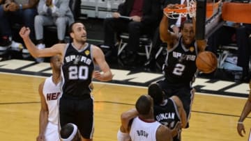 Jun 12, 2014; Miami, FL, USA; San Antonio Spurs forward Kawhi Leonard (2) dunks while defended by Miami Heat center Chris Bosh (1) during the second half of game four of the 2014 NBA Finals at American Airlines Arena. Mandatory Credit: Steve Mitchell-USA TODAY Sports