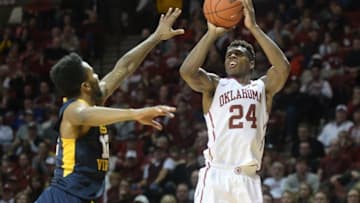 Jan 16, 2016; Norman, OK, USA; Oklahoma Sooners guard Buddy Hield (24) shoots the ball in front of West Virginia Mountaineers guard Tarik Phillip (12) during the second half at Lloyd Noble Center. Mandatory Credit: Mark D. Smith-USA TODAY Sports