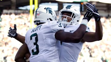 EAST LANSING, MI - SEPTEMBER 09: Running back LJ Scott #3 of the Michigan State Spartans celebrates his first quarter touchdown against the Western Michigan Broncos with wide receiver Cody White #7 of the Michigan State Spartans at Spartan Stadium on September 9, 2017 in East Lansing, Michigan. Michigan State defeated Western Michigan 24-14. (Photo by Duane Burleson/Getty Images)