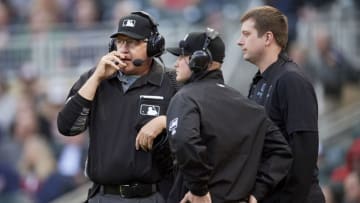 MINNEAPOLIS, MN - APRIL 16: Umpires Paul Emmel #50 and Sean Barber #29 put on the headsets for a replay review during the game between the Minnesota Twins and the Toronto Blue Jays on April 16, 2019 at Target Field in Minneapolis, Minnesota. The Blue Jays defeated the Twins 6-5. (Photo by Hannah Foslien/Getty Images)