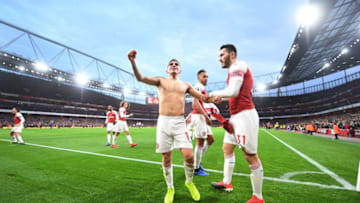 LONDON, ENGLAND - DECEMBER 02: (L) Lucas Torreira celebrates scoring the 4th Arsenal goal with (R) Sead Kolasinac during the Premier League match between Arsenal FC and Tottenham Hotspur at Emirates Stadium on December 1, 2018 in London, United Kingdom. (Photo by Stuart MacFarlane/Arsenal FC via Getty Images)