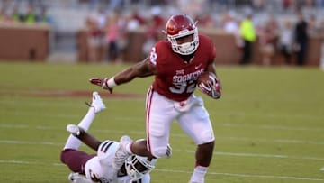 Sep 10, 2016; Norman, OK, USA; Oklahoma Sooners running back Samaje Perine (32) breaks a tackle attempt by Louisiana Monroe Warhawks safety Aaron Townsend (31) during the first quarter at Gaylord Family - Oklahoma Memorial Stadium. Mandatory Credit: Mark D. Smith-USA TODAY Sports