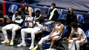 Phoenix Suns players sit courtside in the midst of a 123-101 defeat at the hands of the New Orleans Pelicans (Photo by Sean Gardner/Getty Images)