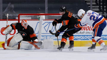 PHILADELPHIA, PENNSYLVANIA - JANUARY 31: Travis Sanheim #6 of the Philadelphia Flyers blocks a shot by Anders Lee #27 of the New York Islanders during the third period at Wells Fargo Center on January 31, 2021 in Philadelphia, Pennsylvania. (Photo by Tim Nwachukwu/Getty Images)