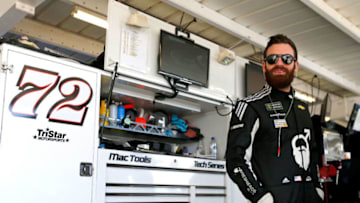 AVONDALE, AZ - MARCH 09: Corey LaJoie, driver of the #72 Schluter-Systems Chevrolet, stands in the garage area during practice for the Monster Energy NASCAR Cup Series TicketGuardian 500 at ISM Raceway on March 9, 2018 in Avondale, Arizona. (Photo by Jonathan Ferrey/Getty Images)