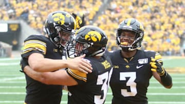 IOWA CITY, IOWA- SEPTEMBER 28: Fullback Brady Ross #36 of the Iowa Hawkeyes celebrates with quarterback Nate Stanley #4 and wide receiver Tyrone Tracy #3 after a touchdown in the first half against the Middle Tennessee Blue Raiders on September 28, 2019 at Kinnick Stadium in Iowa City, Iowa. (Photo by Matthew Holst/Getty Images)