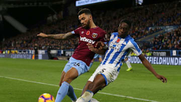 HUDDERSFIELD, ENGLAND - NOVEMBER 10: Ryan Fredericks of West Ham United is tackled by Terence Kongolo of Huddersfield Town during the Premier League match between Huddersfield Town and West Ham United at the John Smith's Stadium on November 10, 2018 in Huddersfield, United Kingdom. (Photo by Nigel Roddis/Getty Images)