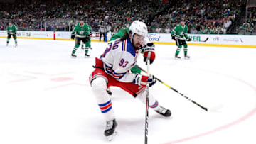 DALLAS, TEXAS - MARCH 10: Mika Zibanejad #93 of the New York Rangers skates the puck against the Dallas Stars during the second period at American Airlines Center on March 10, 2020 in Dallas, Texas. (Photo by Ronald Martinez/Getty Images)