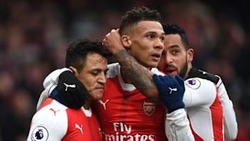 LONDON, ENGLAND - FEBRUARY 11: Alexis Sanchez (L) of Arsenal celebrates scoring the opening goal with his team mates Kieran Gibbs (C) and Theo Walcott (R) during the Premier League match between Arsenal and Hull City at Emirates Stadium on February 11, 2017 in London, England. (Photo by Laurence Griffiths/Getty Images)