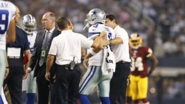 Oct 27, 2014; Arlington, TX, USA; Dallas Cowboys quarterback Tony Romo (9) is helped to the sidelines during the third quarter against the Washington Redskins at AT&T Stadium. Mandatory Credit: Matthew Emmons-USA TODAY Sports