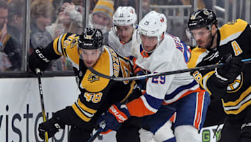 BOSTON, MA. - DECEMBER 19: Matt Grzelcyk #48 of the Boston Bruins takes the puck as Mathew Barzal #13 and Brock Nelson #29 of the New York Islanders surround him during the second period of the NHL game at the TD Garden on December 19, 2019 in Boston, Massachusetts. (Staff Photo By Matt Stone/MediaNews Group/Boston Herald)