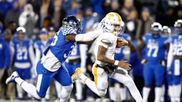 LEXINGTON, KY - OCTOBER 28: Jarrett Guarnanto of the Tennessee Volunteers runs with the ball while defended by Denzil Ware