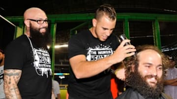 Jul 1, 2015; Miami, FL, USA; Miami Marlins barber Hugo Tandron (left) watches as Marlins starting pitcher Jose Fernandez (center) shaves the head of Marlins superfan Andres Salgado, who has spent 13-plus months growing his hair in honor of Fernandez s return from Tommy John surgery at Marlins Park. Mandatory Credit: Steve Mitchell-USA TODAY Sports