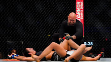 HOUSTON, TX - AUGUST 07: The referee stops the fight after Jessica Penne forces the submission of Karolina Kowalkiewicz by an arm bar in the first round during their Strawweight fight at Toyota Center on July 7, 2021 in Houston, Texas. (Photo by Alex Bierens de Haan/Getty Images )