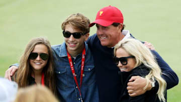 JERSEY CITY, NJ - SEPTEMBER 30: Phil Mickelson of the U.S. Team and his family, wife Amy, son Evan and daughter Sophia pose during Saturday four-ball matches of the Presidents Cup at Liberty National Golf Club on September 30, 2017 in Jersey City, New Jersey. (Photo by Rob Carr/Getty Images)