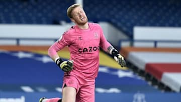 Everton's English goalkeeper Jordan Pickford reacts after an injury during the English Premier League football match between Everton and Burnley at Goodison Park in Liverpool, north west England on March 13, 2021. - RESTRICTED TO EDITORIAL USE. No use with unauthorized audio, video, data, fixture lists, club/league logos or 'live' services. Online in-match use limited to 120 images. An additional 40 images may be used in extra time. No video emulation. Social media in-match use limited to 120 images. An additional 40 images may be used in extra time. No use in betting publications, games or single club/league/player publications. (Photo by PETER POWELL / POOL / AFP) / RESTRICTED TO EDITORIAL USE. No use with unauthorized audio, video, data, fixture lists, club/league logos or 'live' services. Online in-match use limited to 120 images. An additional 40 images may be used in extra time. No video emulation. Social media in-match use limited to 120 images. An additional 40 images may be used in extra time. No use in betting publications, games or single club/league/player publications. / RESTRICTED TO EDITORIAL USE. No use with unauthorized audio, video, data, fixture lists, club/league logos or 'live' services. Online in-match use limited to 120 images. An additional 40 images may be used in extra time. No video emulation. Social media in-match use limited to 120 images. An additional 40 images may be used in extra time. No use in betting publications, games or single club/league/player publications. (Photo by PETER POWELL/POOL/AFP via Getty Images)