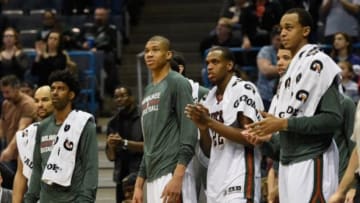 Apr 12, 2015; Milwaukee, WI, USA; Milwaukee Bucks guard O.J. Mayo (00), forward Giannis Antetokounmpo (34), guard Khris Middleton (22), and center John Henson (31) react after the Bucks defeated the Brooklyn Nets 96-73 to clinch a playoff spot at BMO Harris Bradley Center. Mandatory Credit: Benny Sieu-USA TODAY Sports