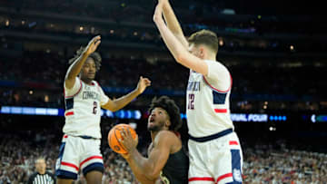 Apr 1, 2023; Houston, TX, USA; Miami (Fl) Hurricanes forward Norchad Omier (15) shoots the ball against Connecticut Huskies guard Tristen Newton (2) and center Donovan Clingan (32) during the second half in the semifinals of the Final Four of the 2023 NCAA Tournament at NRG Stadium. Mandatory Credit: Bob Donnan-USA TODAY Sports