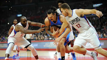 December 21, 2015; Los Angeles, CA, USA; Oklahoma City Thunder center Steven Adams (12) plays for the ball against Los Angeles Clippers forward Luc Richard Mbah a Moute (12) and forward Blake Griffin (32) during the first half at Staples Center. Mandatory Credit: Gary A. Vasquez-USA TODAY Sports