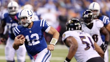 Oct 5, 2014; Indianapolis, IN, USA; Indianapolis Colts quarterback Andrew Luck (12) runs the ball in for a touchdown against the Baltimore Ravens at Lucas Oil Stadium. Mandatory Credit: Brian Spurlock-USA TODAY Sports