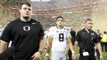 Jan 12, 2015; Arlington, TX, USA; Oregon Ducks quarterback Marcus Mariota (8) walks off the field after losing to the Ohio State Buckeyes in the 2015 CFP National Championship Game at AT&T Stadium. Mandatory Credit: Tim Heitman-USA TODAY Sports
