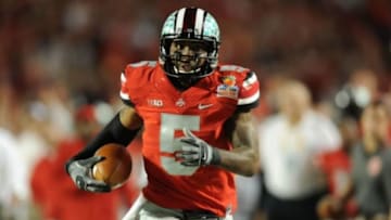 Jan 3, 2014; Miami Gardens, FL, USA; Ohio State Buckeyes quarterback Braxton Miller (5) runs for a touchdown in the first half against the Clemson Tigers during the 2014 Orange Bowl college football game at Sun Life Stadium. Mandatory Credit: Steve Mitchell-USA TODAY Sports