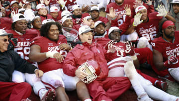 NORMAN, OK - DECEMBER 3: Head Coach Bob Stoops of the Oklahoma Sooners poses for pictures with the team after the game against the Oklahoma State Cowboys December 3, 2016 at Gaylord Family-Oklahoma Memorial Stadium in Norman, Oklahoma. Oklahoma defeated Oklahoma State 38-20 to become Big XII champions. (Photo by Brett Deering/Getty Images)