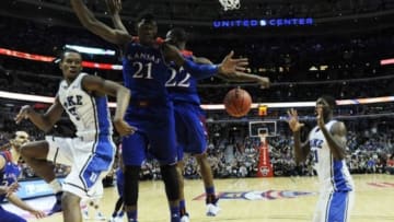Nov 12, 2013; Chicago, IL, USA; Duke Blue Devils forward Rodney Hood (5) passes the ball around Kansas Jayhawks center Joel Embiid (21) and guard Andrew Wiggins (22) during the first half at United Center. Mandatory Credit: David Banks-USA TODAY Sports