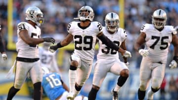 Dec 18, 2016; San Diego, CA, USA; Oakland Raiders cornerback David Amerson (29) celebrates with strong safety T.J. Carrie (38) outside linebacker Bruce Irvin (51) and defensive tackle Darius Latham (75) after stopping San Diego Chargers wide receiver Tyrell Williams (16) short of a first down during the fourth quarter at Qualcomm Stadium. Mandatory Credit: Jake Roth-USA TODAY Sports