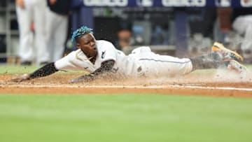 MIAMI, FLORIDA - JUNE 09: Jazz Chisholm Jr. #2 of the Miami Marlins slides home safely to score a run during the fifth inning against the Washington Nationals at loanDepot park on June 09, 2022 in Miami, Florida. (Photo by Michael Reaves/Getty Images)