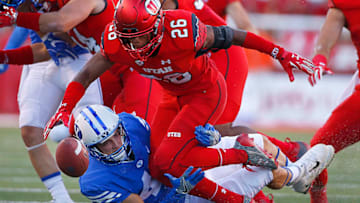 SALT LAKE CITY, UT - SEPTEMBER 10: Terrell Burgess #26 of the Utah Utes fumbles the ball after he was hit by Alema Pilimai #45 of the Brigham Young Cougars during the first half of an college football game, at Rice Eccles Stadium on September 10, 2016 in Salt Lake City, Utah. (Photo by George Frey/Getty Images)
