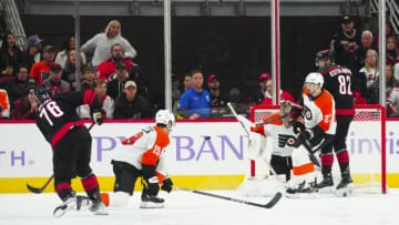Nov 15, 2023; Raleigh, North Carolina, USA; Philadelphia Flyers goaltender Carter Hart (79) left wing Noah Cates (27) and right wing Garnet Hathaway (19) go out to stop eat scoring attempt shot by Carolina Hurricanes defenseman Brady Skjei (76) during the second period at PNC Arena. Mandatory Credit: James Guillory-USA TODAY Sports