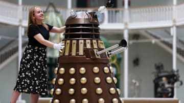 EDINBURGH, SCOTLAND - JULY 21: Liv Mullen from the National Museum of Scotland poses with a Dalek ahead of the new exhibition, 'Doctor Who Worlds of Wonder', on July 21, 2022 in Edinburgh, Scotland. This exhibition, which runs from 10 December 2022 to 30 April 2023, explores the science behind the global hit television series Doctor Who and will give fans a chance to experience the Doctor's adventures from a scientific perspective. (Photo by Jeff J Mitchell/Getty Images)