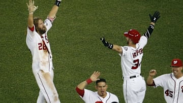 Jun 15, 2016; Washington, DC, USA; Washington Nationals left fielder Jayson Werth (28) celebrates with Nationals right fielder Bryce Harper (34) after hitting the game-winning single against the Chicago Cubs in the twelfth inning at Nationals Park. The Nationals won 5-4. Mandatory Credit: Geoff Burke-USA TODAY Sports