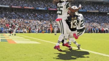 Oct 5, 2014; San Diego, CA, USA; New York Jets defensive back Phillip Adams (right) intercepts a pass intended for San Diego Chargers wide receiver Keenan Allen (13) as Jets free safety Calvin Pryor (25) knocks Allen
