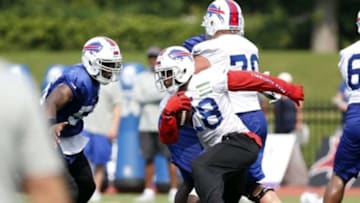 Jul 21, 2014; Pittsford, NY, USA; Buffalo Bills running back C.J. Spiller (28) carries the ball as linebacker Jacquies Smith (56) pursues during training camp at St John Fisher College. Mandatory Credit: Kevin Hoffman-USA TODAY Sports
