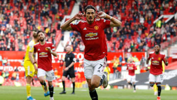 Manchester United's Uruguayan striker Edinson Cavani celebrates scoring the opening goal during the English Premier League football match between Manchester United and Fulham at Old Trafford in Manchester, north west England, on May 18, 2021. - RESTRICTED TO EDITORIAL USE. No use with unauthorized audio, video, data, fixture lists, club/league logos or 'live' services. Online in-match use limited to 120 images. An additional 40 images may be used in extra time. No video emulation. Social media in-match use limited to 120 images. An additional 40 images may be used in extra time. No use in betting publications, games or single club/league/player publications. (Photo by PHIL NOBLE / POOL / AFP) / RESTRICTED TO EDITORIAL USE. No use with unauthorized audio, video, data, fixture lists, club/league logos or 'live' services. Online in-match use limited to 120 images. An additional 40 images may be used in extra time. No video emulation. Social media in-match use limited to 120 images. An additional 40 images may be used in extra time. No use in betting publications, games or single club/league/player publications. / RESTRICTED TO EDITORIAL USE. No use with unauthorized audio, video, data, fixture lists, club/league logos or 'live' services. Online in-match use limited to 120 images. An additional 40 images may be used in extra time. No video emulation. Social media in-match use limited to 120 images. An additional 40 images may be used in extra time. No use in betting publications, games or single club/league/player publications. (Photo by PHIL NOBLE/POOL/AFP via Getty Images)