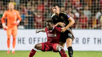 HONG KONG, HONG KONG - JULY 22: Liverpool FC forward Divock Origi (L) fights for the ball with Leicester City FC defender Harry Maguire during the Premier League Asia Trophy match between Liverpool FC and Leicester City FC at Hong Kong Stadium on July 22, 2017 in Hong Kong, Hong Kong. (Photo by Victor Fraile/Getty Images )