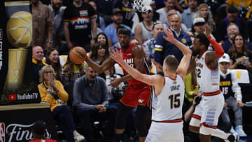 Jun 12, 2023; Denver, Colorado, USA; Miami Heat forward Jimmy Butler (22) passes against Denver Nuggets center Nikola Jokic (15) during the first quarter of game five of the 2023 NBA Finals at Ball Arena. Mandatory Credit: Isaiah J. Downing-USA TODAY Sports