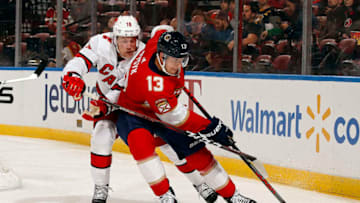 SUNRISE, FL - OCT. 8: Mark Pysyk #13 of the Florida Panthers skates with the puck against Ryan Dzingel #18 of the Carolina Hurricanes at the BB&T Center on October 8, 2019 in Sunrise, Florida. (Photo by Eliot J. Schechter/NHLI via Getty Images)