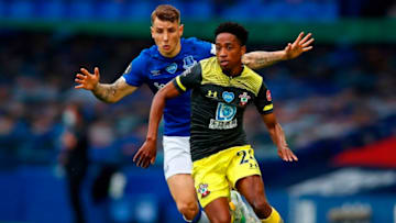 Everton's French defender Lucas Digne (L) vies with Southampton's English defender Kyle Walker-Peters during the English Premier League football match between Everton and Southampton at Goodison Park in Liverpool, north west England on July 9, 2020. (Photo by Clive Brunskill / POOL / AFP) / RESTRICTED TO EDITORIAL USE. No use with unauthorized audio, video, data, fixture lists, club/league logos or 'live' services. Online in-match use limited to 120 images. An additional 40 images may be used in extra time. No video emulation. Social media in-match use limited to 120 images. An additional 40 images may be used in extra time. No use in betting publications, games or single club/league/player publications. / (Photo by CLIVE BRUNSKILL/POOL/AFP via Getty Images)