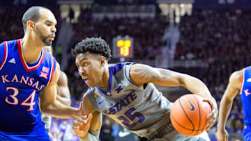 20 February 2016: Kansas State Wildcats forward Wesley Iwundu (25) drives on Kansas Jayhawks forward Perry Ellis (34) in a Big 12 matchup between the