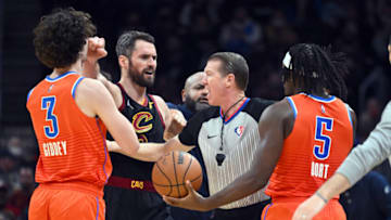 Referee Ed Malloy #14 tries to separate Kevin Love #0 of the Cleveland Cavaliers from Josh Giddey #3 and Luguentz Dort #5 of the Oklahoma City Thunder after they began to argue after battling for a loose ball during the fourth quarter at Rocket Mortgage Fieldhouse on January 22, 2022 in Cleveland, Ohio. The Cavaliers defeated the Thunder 94-87. NOTE TO USER: User expressly acknowledges and agrees that, by downloading and/or using this photograph, user is consenting to the terms and conditions of the Getty Images License Agreement. (Photo by Jason Miller/Getty Images)